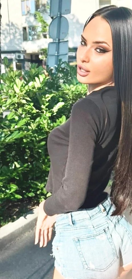 Lana Bajc in a black top and denim photographed in the city.