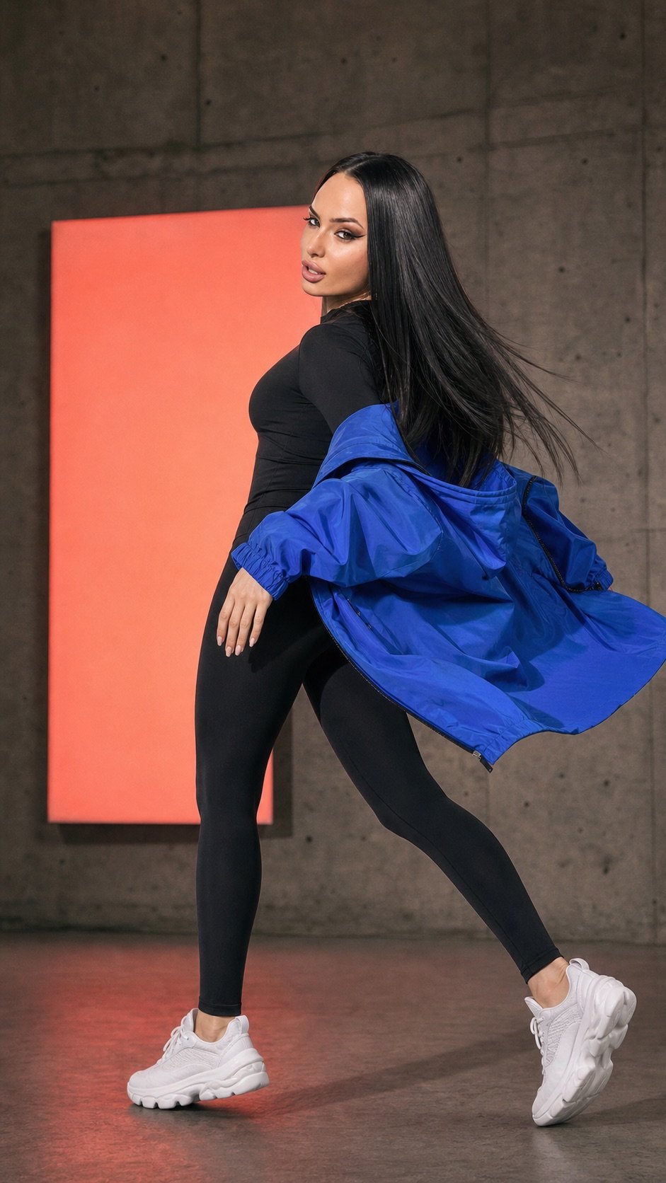 Lana Bajc in an electric-blue performance jacket on a concrete studio set.