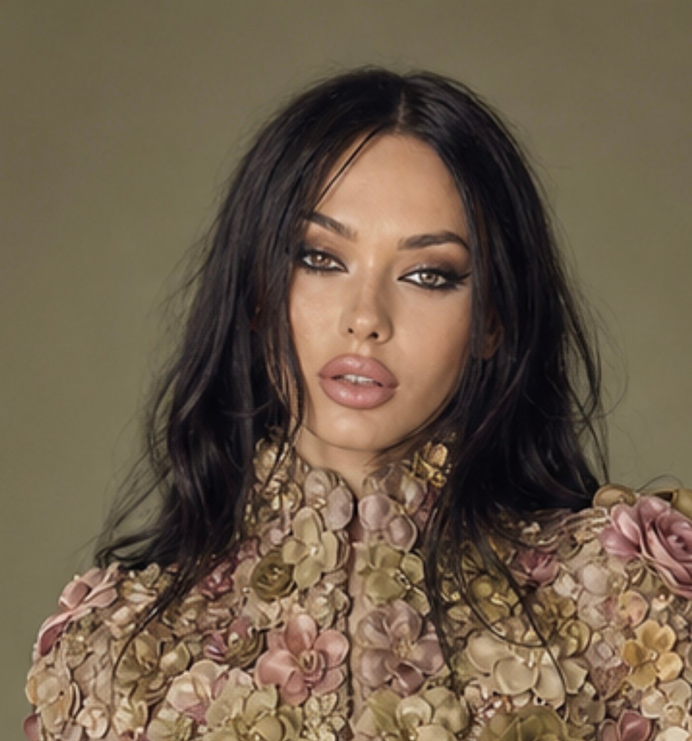 Lana Bajc in a sculptural floral couture top against an olive backdrop.
