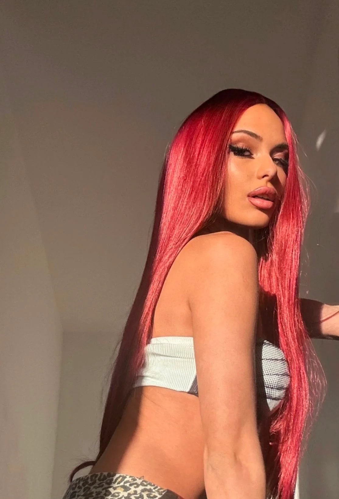 Lana Bajc with vivid red hair in warm directional sunlight.